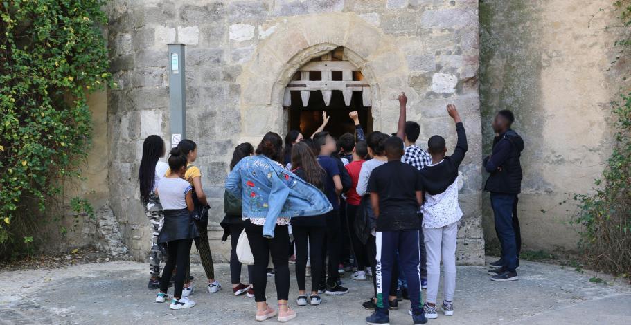 Un groupe de collégiens devant la herse du donjon de Blandy